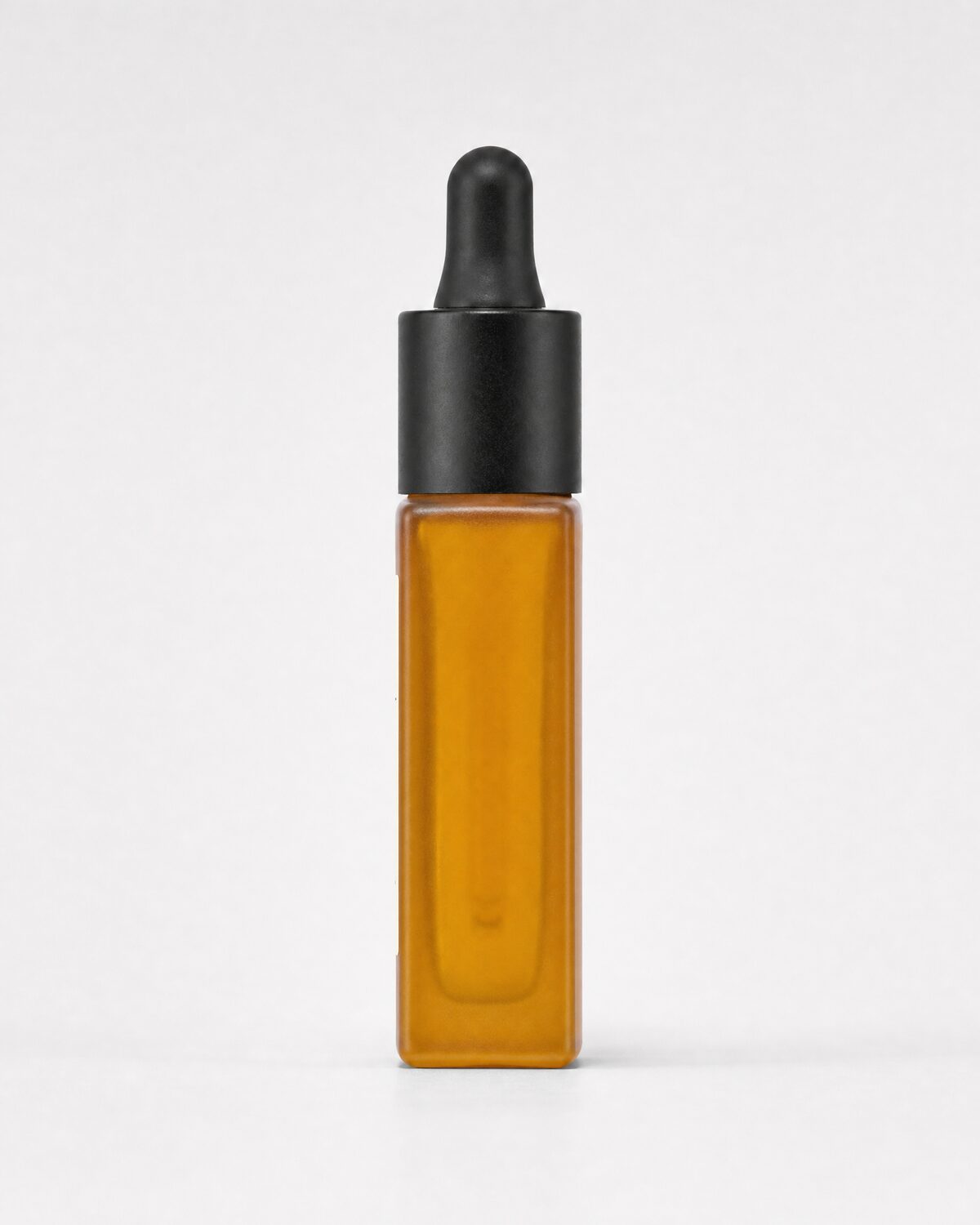 Amber glass serum bottle with dropper, side view