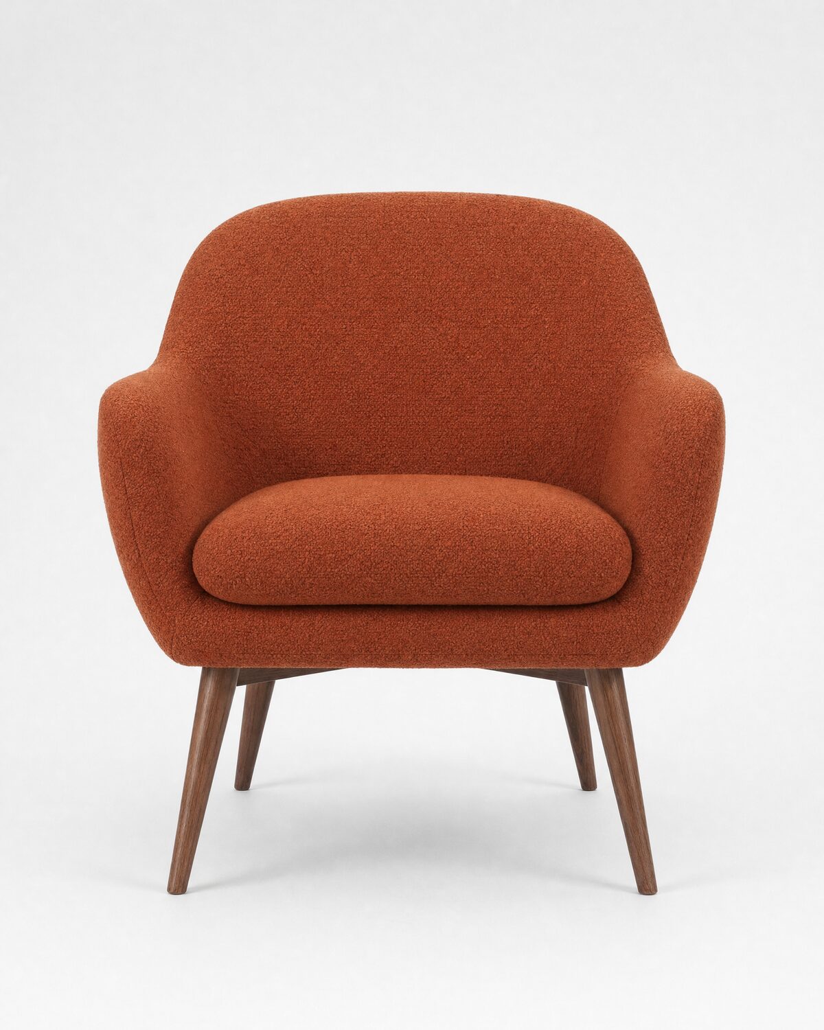 Lounge armchair in rust bouclé and walnut, front view