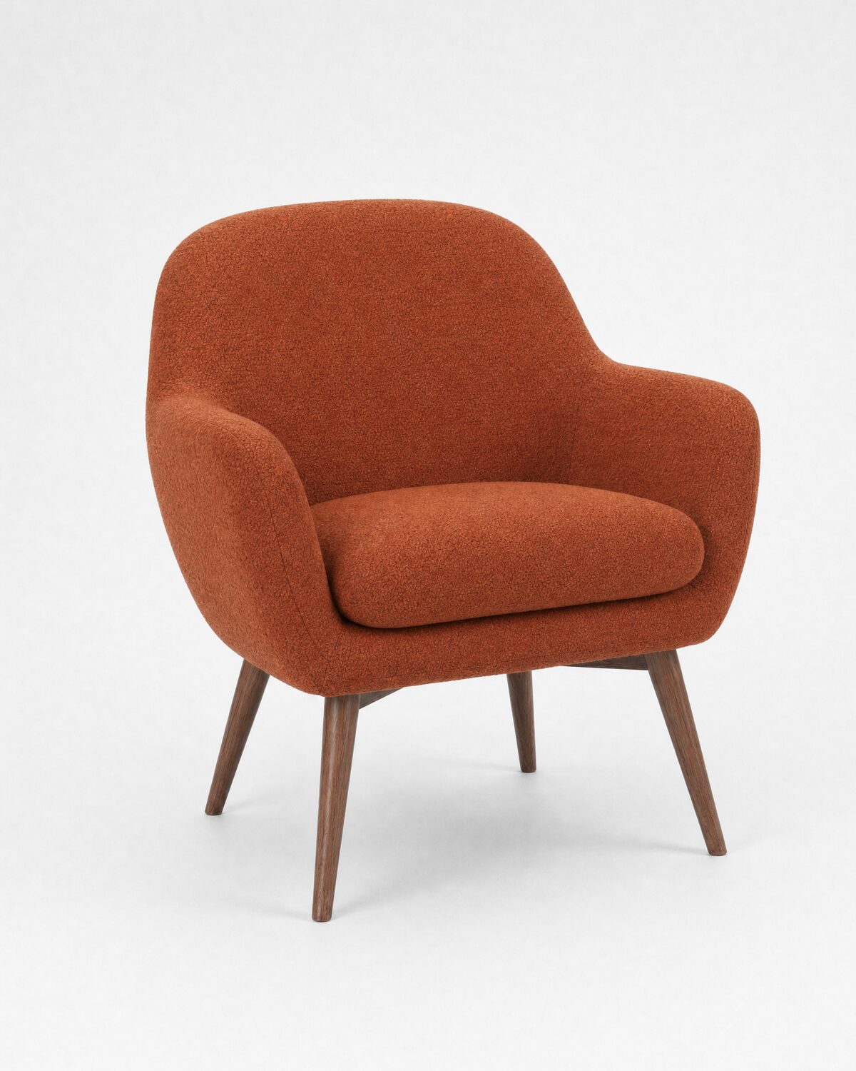 Lounge armchair in rust bouclé and walnut, three-quarter view
