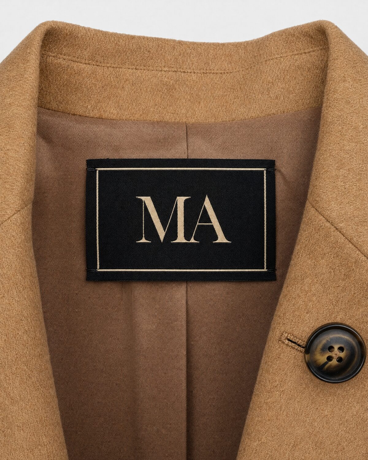 Camel wool blazer on a ghost mannequin, close-up